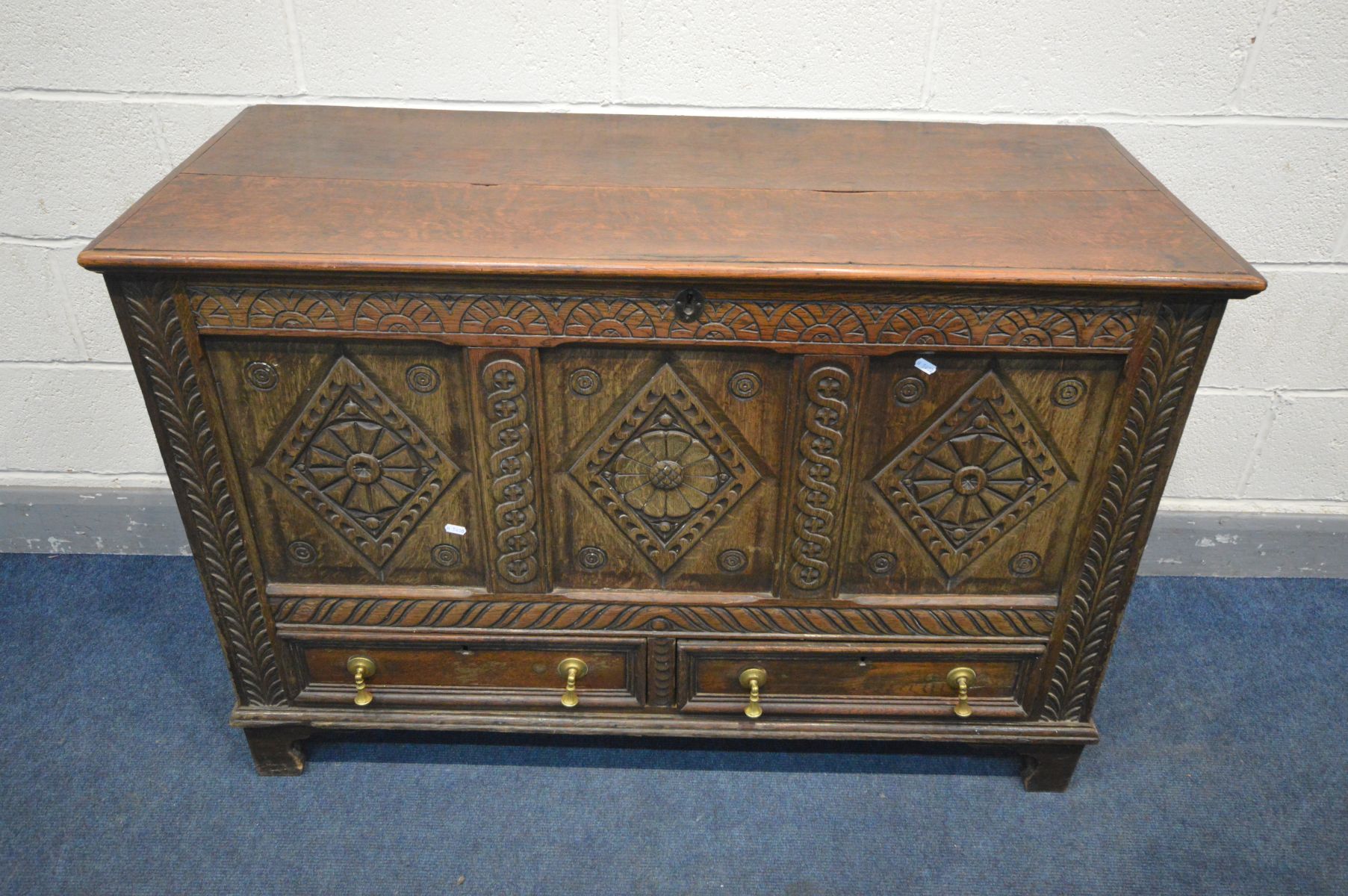 A 19TH CENTURY OAK MULE CHEST, three carved panels above two drawers, width 124cm x depth 52cm x