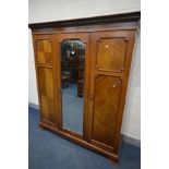 AN EDWARDIAN MAHOGANY TRIPLE DOOR WARDROBE, with a central mirror, on bracket feet, width 173cm x