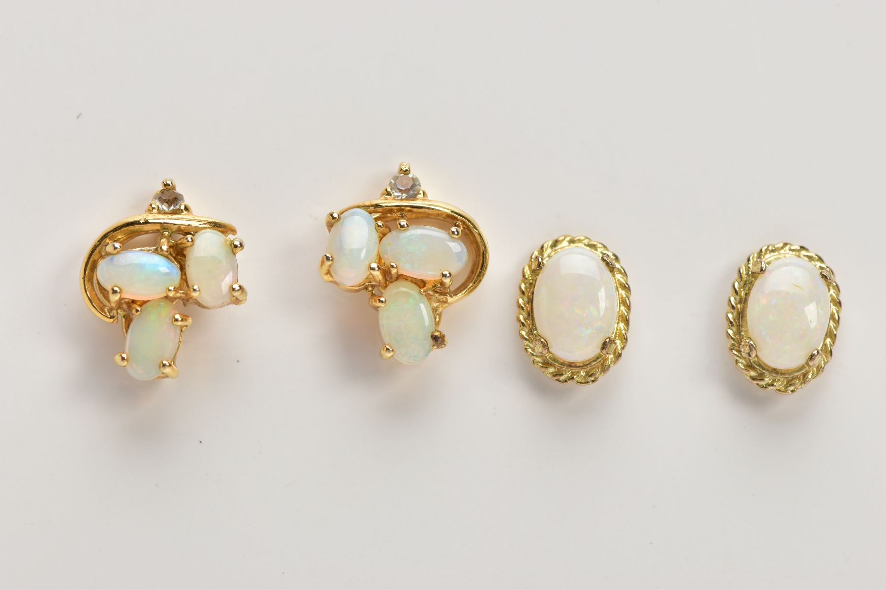TWO PAIRS OF OPAL EARRINGS, the first of an oval design, set with an oval opal cabochon, within a