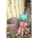 A LARGE COLLECTION OF MOSTLY SMALL TERRECOTA POTS together with a Hozelock pipe reel (50+)