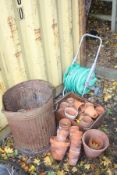 A LARGE COLLECTION OF MOSTLY SMALL TERRECOTA POTS together with a Hozelock pipe reel (50+)