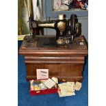 A CASED VINTAGE 'JONES' SEWING MACHINE, No. 87445, with a small box of threads, etc