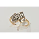 A YELLOW METAL DIAMOND DRESS RING, of an asymmetrical design, set with round brilliant cut and Swiss