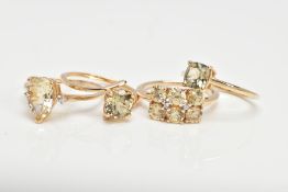 FOUR 9CT GOLD GEM SET DRESS RINGS, each set with pale yellowish green stones (untested) of various