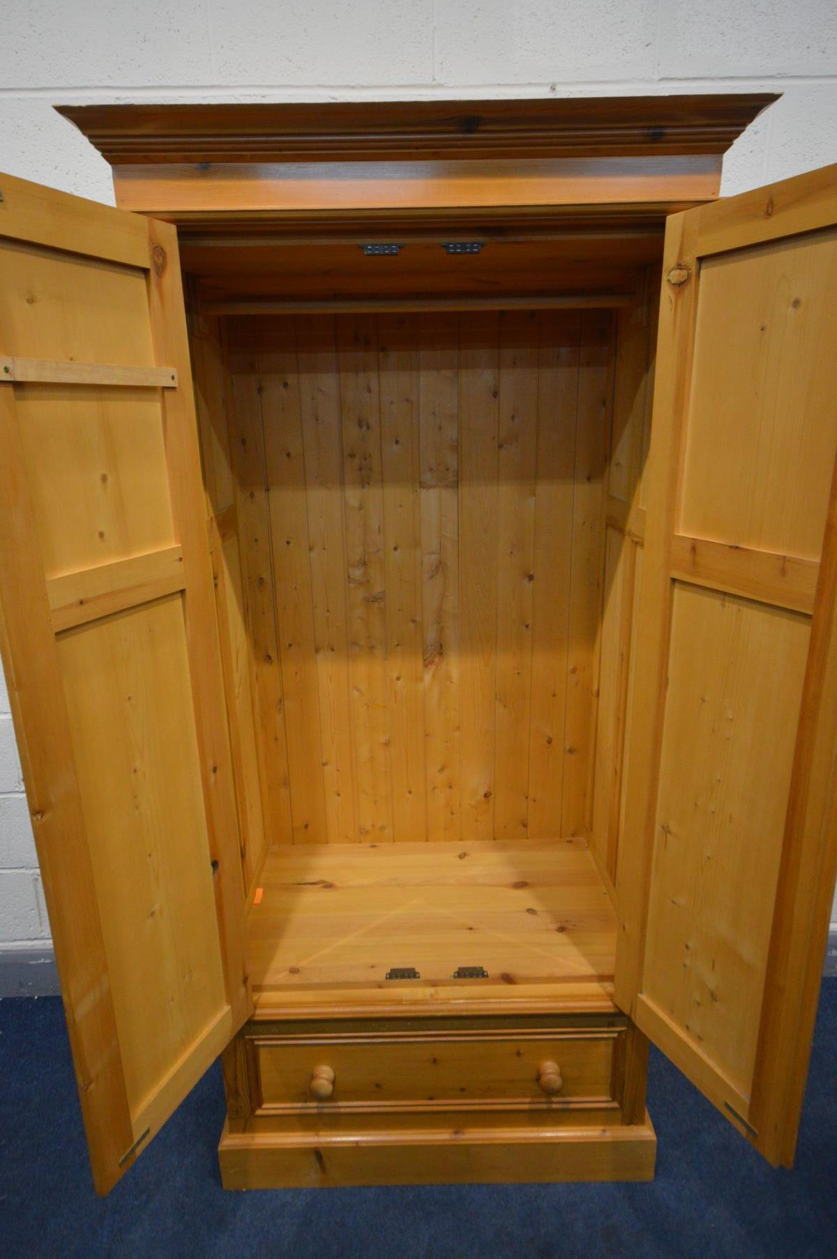 A PANELLED PINE DOUBLE DOOR WARDROBE, above a single drawer, width 97cm x depth 61cm x height 196cm - Image 2 of 2