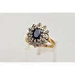 AN 18CT GOLD SAPPHIRE AND DIAMOND CLUSTER RING, designed with a central oval cut blue sapphire,