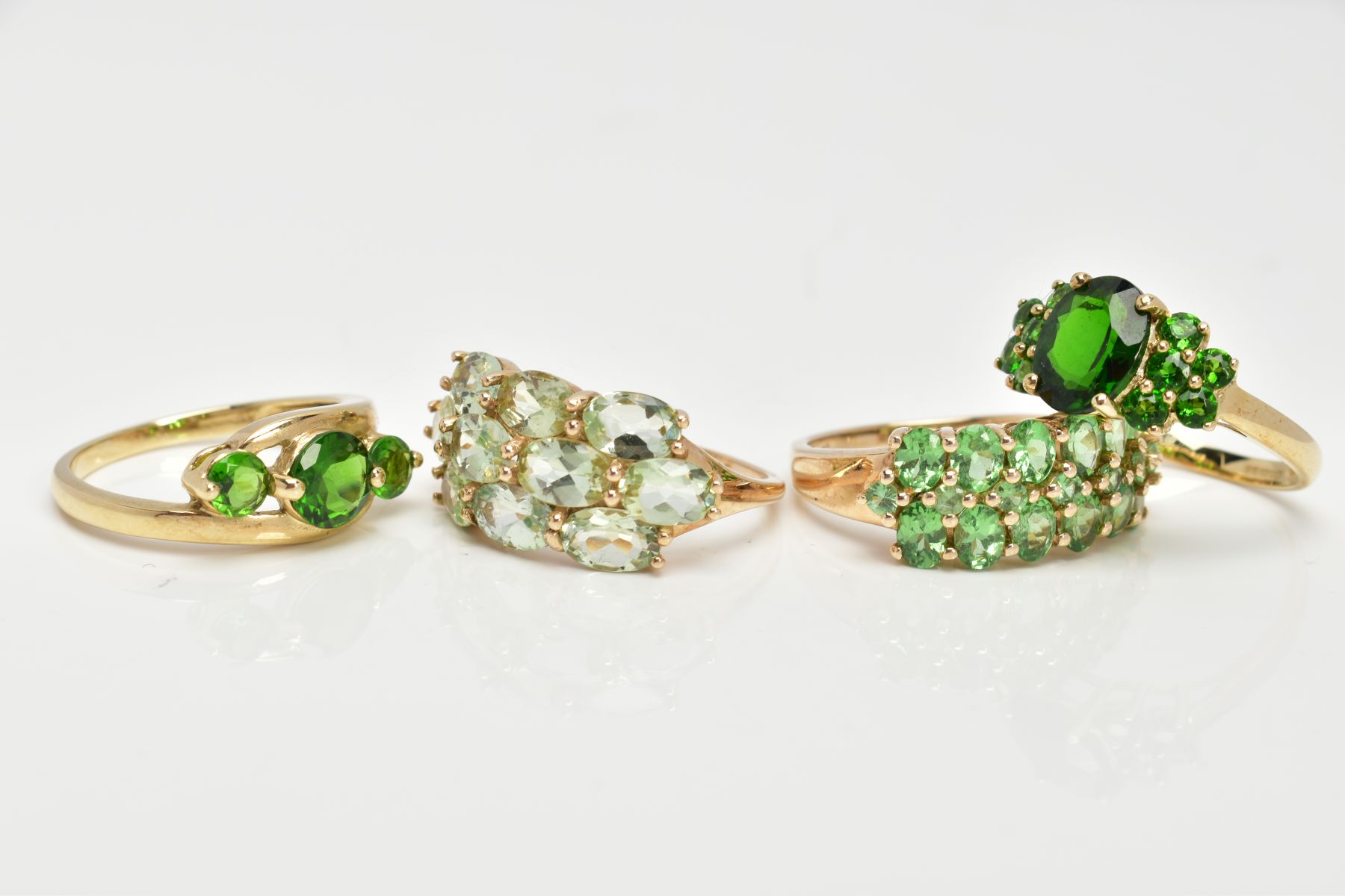 FOUR 9CT GOLD GEMSET RINGS, to include a three stone ring, assessed as circular cut diopside, - Image 2 of 3