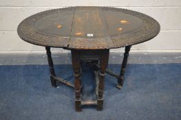 A SMALL 19TH CENTURY CARVED OAK GATE LEG TABLE, open width 94cm x closed width 26cm x depth 67cm x