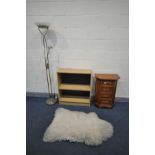 A SMALL CHERRYWOOD CHEST OF FOUR DRAWERS, with canted front corners, a sheep wool rug, open bookcase