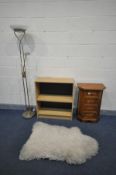 A SMALL CHERRYWOOD CHEST OF FOUR DRAWERS, with canted front corners, a sheep wool rug, open bookcase