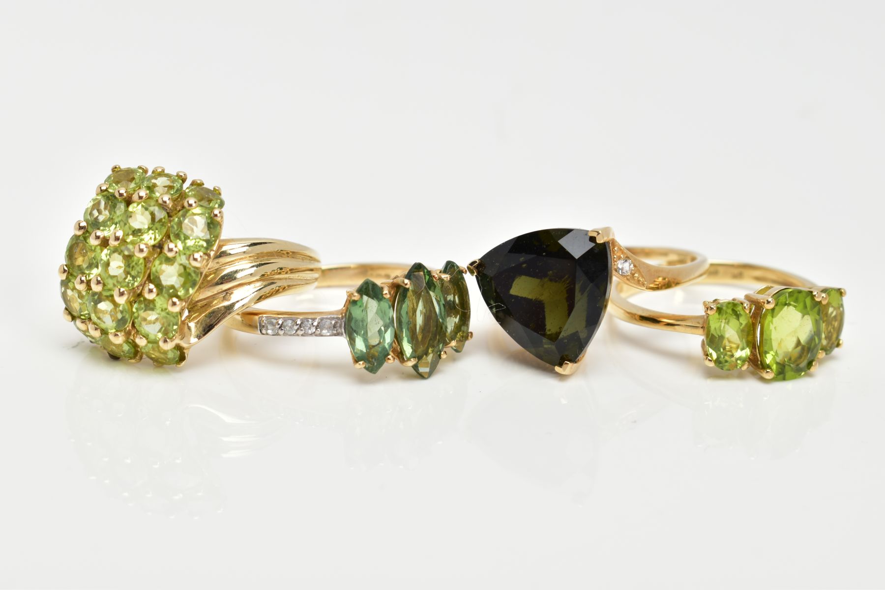 FOUR 9CT GOLD GEMSET RINGS, to include a three stone ring, oval cut peridot, prong set with - Image 2 of 3