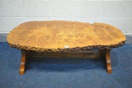 A RUSTIC BURR WOOD COFFEE TABLE, the top formed of two planks, on a trestle base united by a