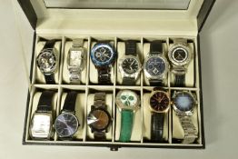 A WATCH DISPLAY CASE WITH WATCHES, a black and glass panelled watch display case, with twelve