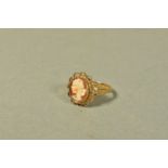 A 9CT GOLD CAMEO RING, oval form depicting a lady in profile, collet mount and scallop edge