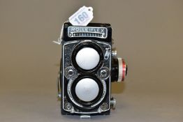 A ROLLEIFLEX 2.8E TLR CAMERA fitted with 80mm f2.8 lenses, one Planar and one Heidosmat ( slightly