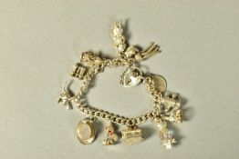 A HEAVY SILVER CHARM BRACELET, each link stamped with a lion passant, suspending thirteen charms, in