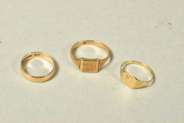 THREE RINGS, the first a signet ring with engraved scrolling initials and personal engraving,