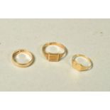 THREE RINGS, the first a signet ring with engraved scrolling initials and personal engraving,