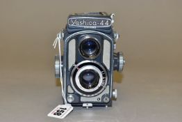 A YASHICA 44A TLR IN GREY fitted with 60mm f3.5 lenses ( viewfinder lid bent)