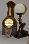 AN OAK ANEROID WHEEL BAROMETER, having mercury Fahrenheit and centigrade thermometer by Barker &