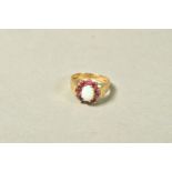 A 9CT GOLD OPAL AND PINK SAPPHIRE CLUSTER RING, the central oval opal cabochon within a circular