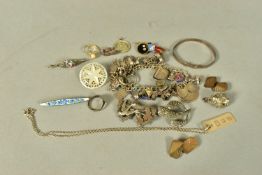 A BAG OF ASSORTED JEWELLERY, to include a white metal charm bracelet, suspending thirty-two white