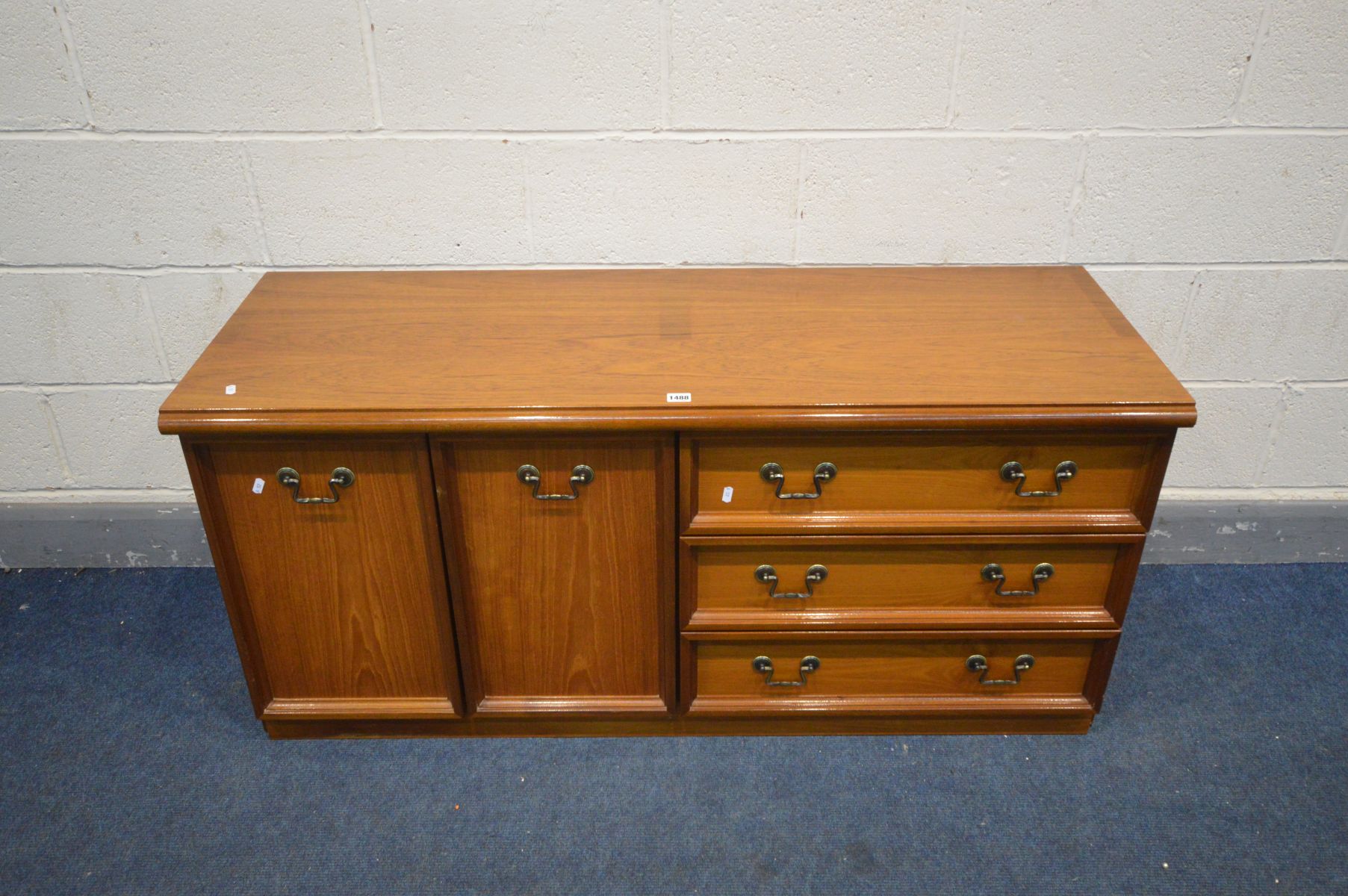 A MEREDEW TEAK SIDEBOARD with three drawers, width 135cm x depth 48cm x height 43cm, along with a