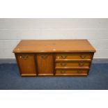 A MEREDEW TEAK SIDEBOARD with three drawers, width 135cm x depth 48cm x height 43cm, along with a