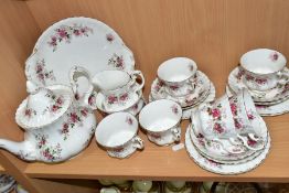 A ROYAL ALBERT LAVENDER ROSE TEA SET, comprising a tea pot and cover, height 19cm, a milk jug, a