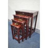 A RED LAQUERED ORIENTAL QUARTETTO NEST OF THREE TABLES, with chinoiserie decoration, and a single