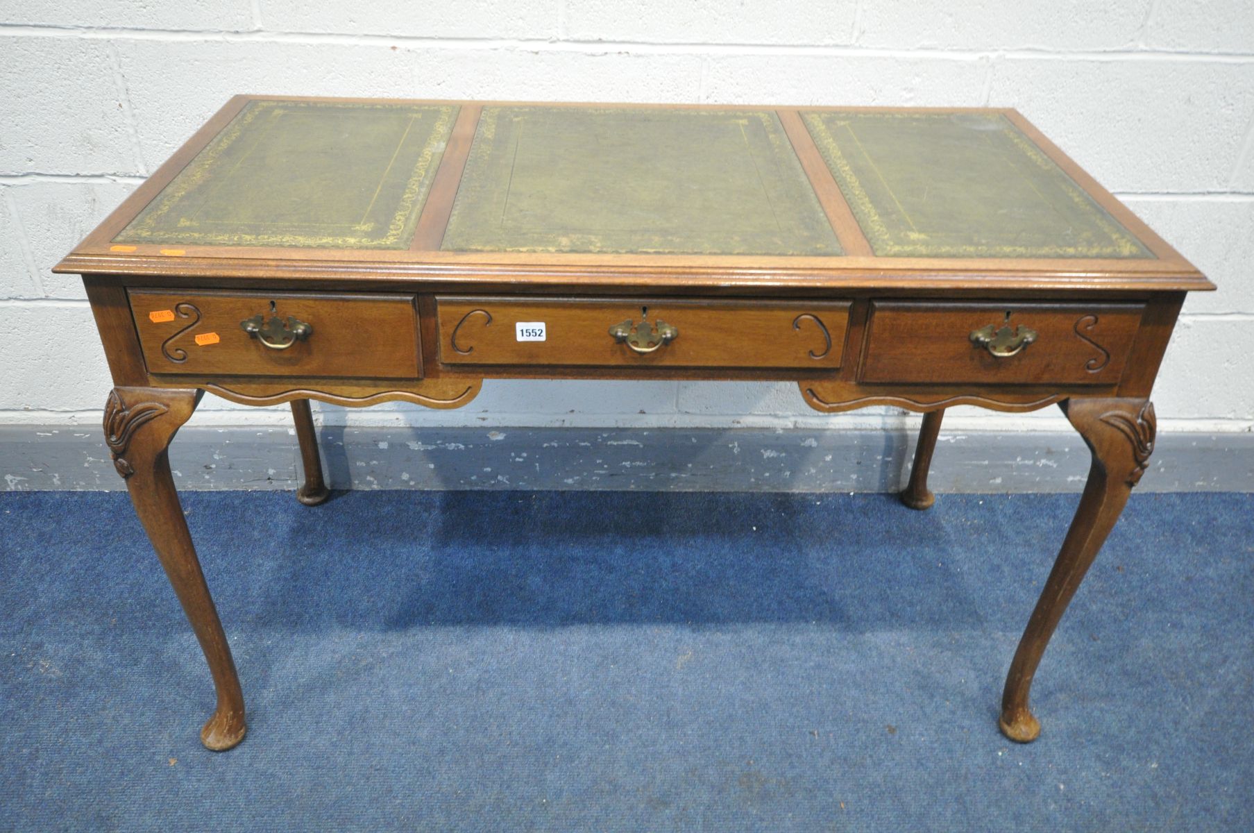 A REPRODUCTION VICTORIAN STYLE WRITING TABLE, with a triple gilt tooled and green leather inlay