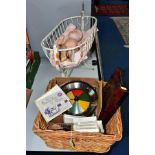 A METAL DOLLS CRADLE CONTAINING AN ARMAND MARSEILLE DOLL WITH A BASKET OF VINTAGE GAMES, to