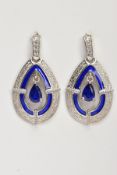 A PAIR OF WHITE METAL OPENWORK DROP EARRINGS, each of an openwork tear drop form, set with a pear