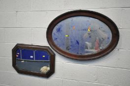 AN EARLY TO MID 20TH CENTURY OAK BEVELLED EDGE WALL MIRROR, with canted corners, and a mahogany oval