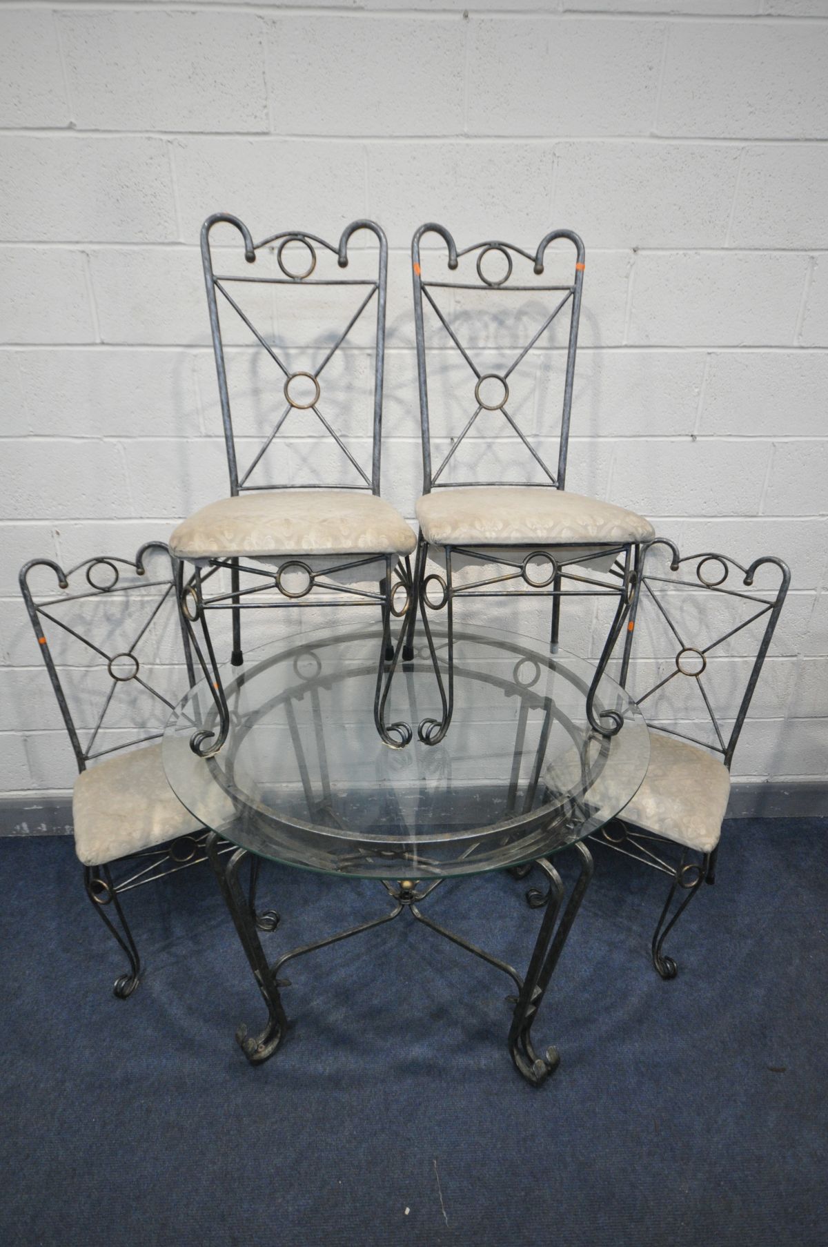 A METAL AND CIRCULAR GLASS TOPPED DINING TABLE, diameter 107cm x height 76cm, and four chairs (5) (