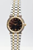 A LADYS GUCCI WRISTWATCH, two tone lady's mechanical watch with a black face, date window at the six