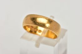 A 22CT GOLD BAND RING, a slightly courted plain polished band ring with signs of a rubbed engraving,