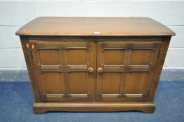 AN ERCOL GOLDEN DAWN TWO DOOR ENTERTAINMENT CABINET, with a hinged top, and an adjustable central