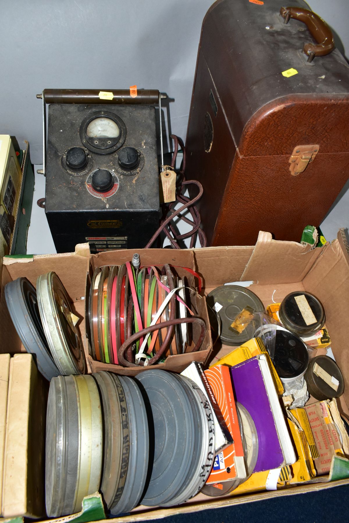 A SIMPLEX AMPRO PROJECTOR, WITH RUNBAKEN TRANSFORMER AND A BOX OF FILMS, comprising a cased