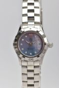 A LADY'S TAG HEUER AQUARACER WRISTWATCH, a polished steel watch, rotating bezel with a blue mother