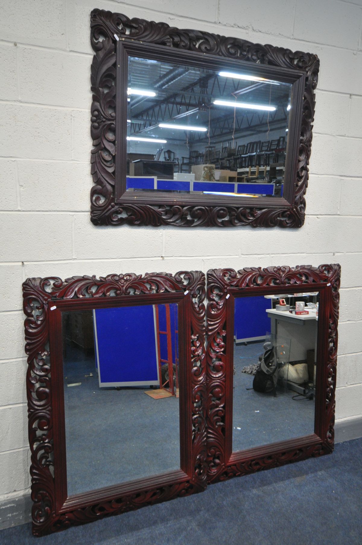 THREE LATE 20TH CENTURY FOLIATE WOODEN FRAMED BEVELLED EDGE WALL MIRRORS, all painted in burgundy,