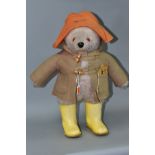 A GABRIELLE DESIGNS PADDINGTON BEAR, extensive fading and wear to duffle coat, hat and yellow Dunlop