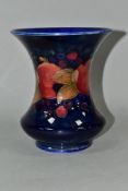 A MOORCROFT POTTERY WAISTED BALUSTER VASE, the exterior decorated with a pomegranate design on a