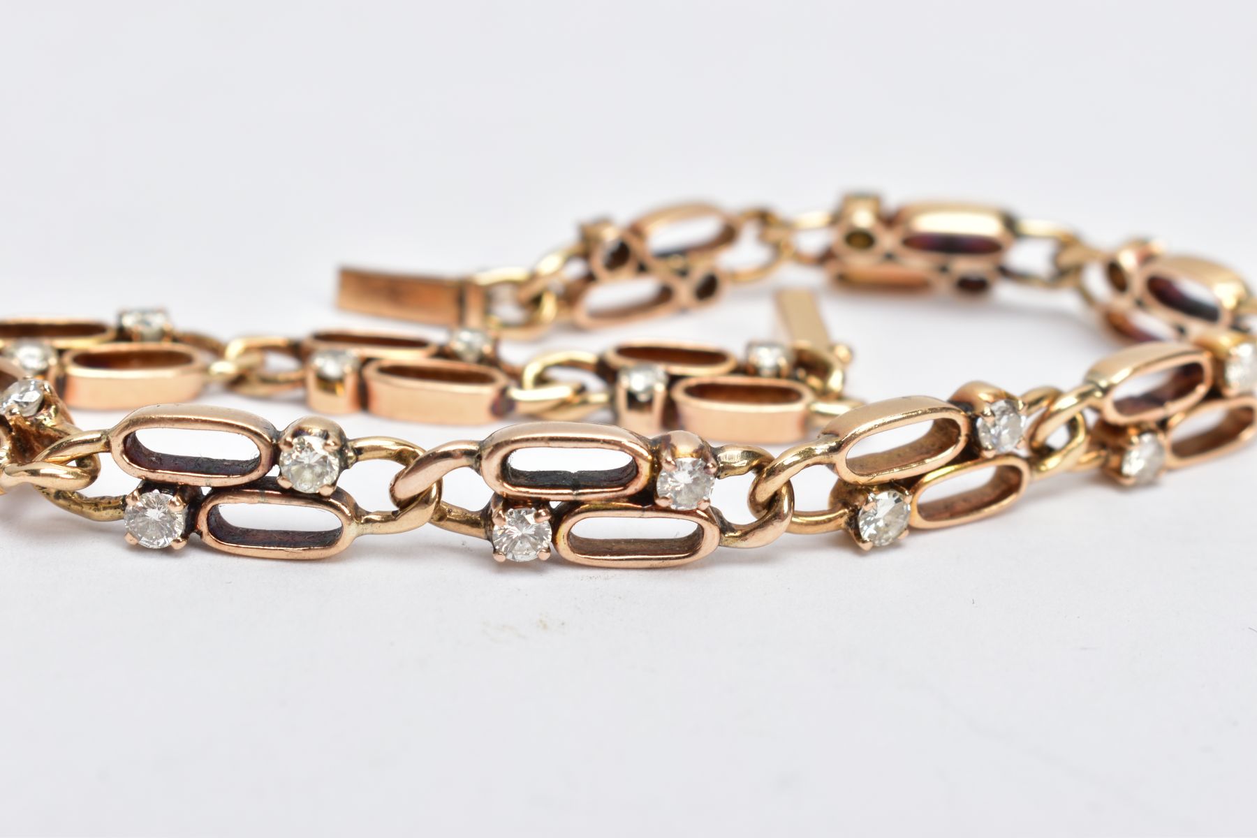 A YELLOW METAL DIAMOND LINE BRACELET, designed with double oval openwork links, each link set with - Image 3 of 3