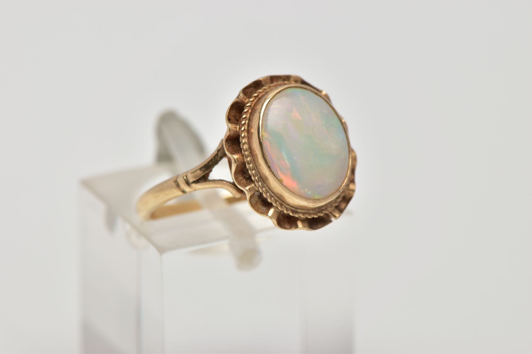 A 9CT GOLD OPAL DRESS RING, designed as an oval cabochon within a collet mount, swag surround, - Image 4 of 4