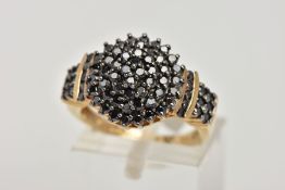 A 9CT GOLD BLACK DIAMOND CLUSTER RING, of a circular design, set with round brilliant cut black