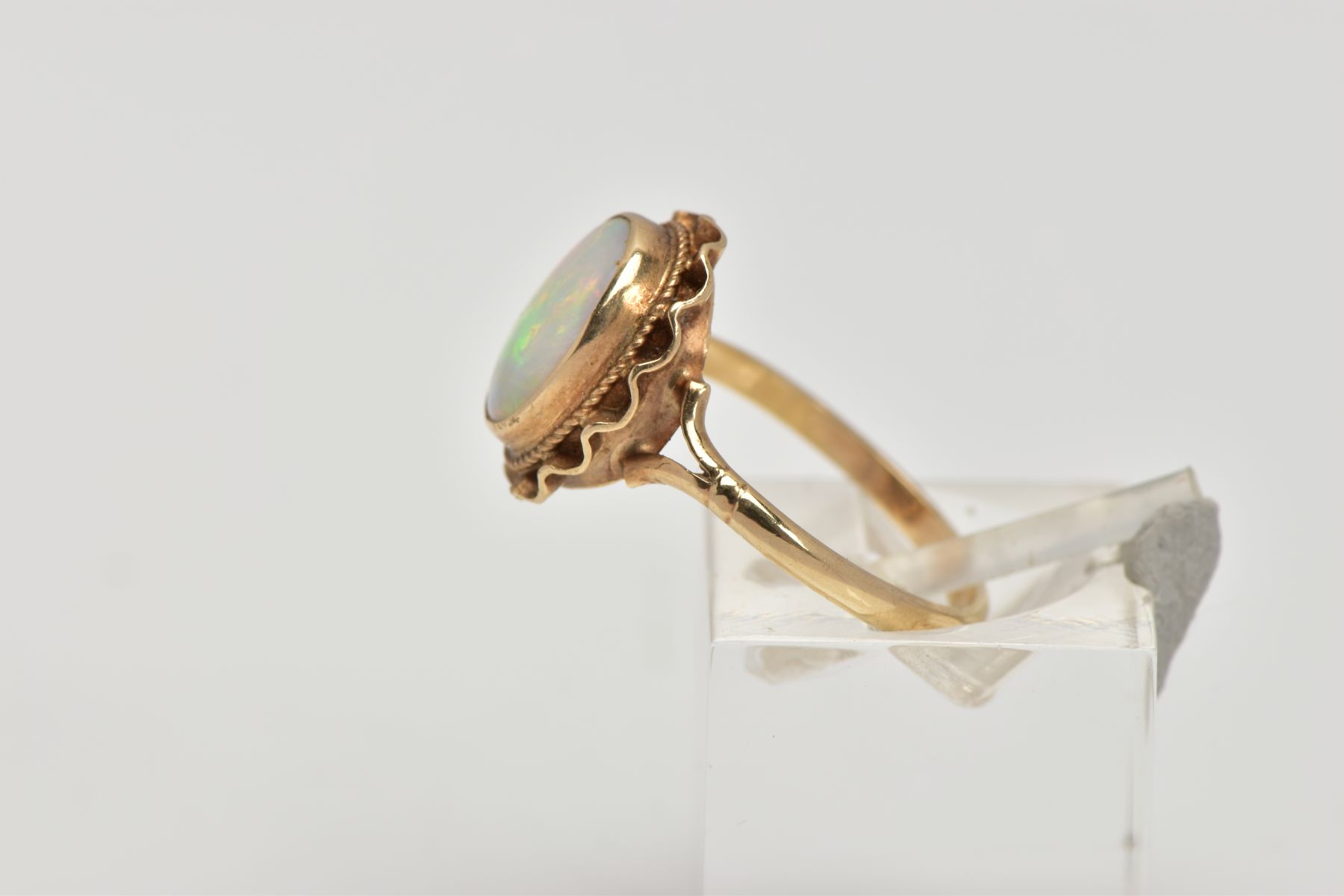 A 9CT GOLD OPAL DRESS RING, designed as an oval cabochon within a collet mount, swag surround, - Image 2 of 4