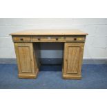 A 19TH CENTURY PINE PEDESTAL DESK, with three frieze drawers over two pedestals with single cupboard