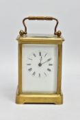 A BRASS CARRIAGE CLOCK, white dial with Roman numerals, four glass panels with an oval glass panel