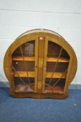 AN ART DECO WALNUT SUNBURST TWO DOOR CHINA CABINET, with wooden shelves, width 122cm x depth 34cm